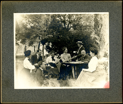 Group of Ellen White workers sitting outside writing in Australia