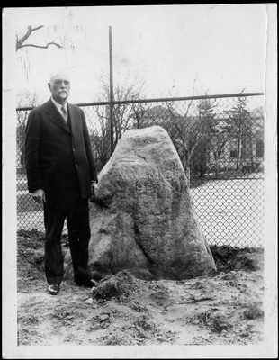 Arthur G. Daniells standing beside the A.A.M.C. rock
