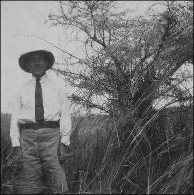 Eric Beavon beside a thorn bush, Kenya