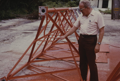 Don Myers standing by tower section of AWR in Guam