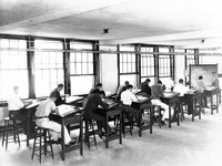 Professor Standish with unknown students in Drafting class at Madison College
