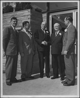 E. A. Sutherland posing with four unknown men at the opening of the Madison branch of the First American National Bank