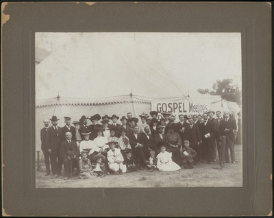 William Simpson with a group of people in front of a gospel meeting tent in Los Angeles