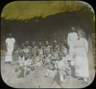 Cora McElhany posing with native New Guineans