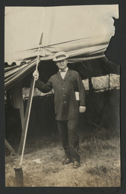 Carlyle Haynes posing outside tent