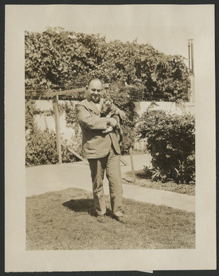 Carlyle Haynes in a backyard holding a cat