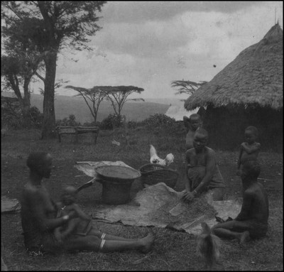 Kisii women thrashing corn with children surrounding