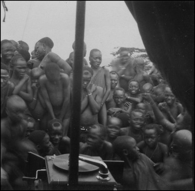 Kisii natives gathered around a phonograph player