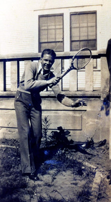 Student Playing Tennis Outside West Hall