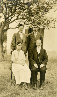 Here are the four graduates of our school (12 grades) who finished in 1917. The young man to the left standing, Jos Replogle, is a missionary in Peru now. The one at his side, Daniel Weiss, is Sec. and Treas. Of our mission in northern Argentina. The young lady sitting, who was our daughter for three years, has been teaching in Chile in our school at Peia for two years. The young man sitting is Jos Journo, Bible worker in S. Argentina