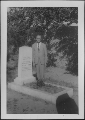 Unknown man posing by Elmer Coulston's grave