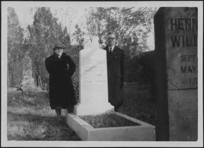 Dorothy and Otto Christensen posing by Elmer Coulston's grave