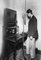 Stanley Hall standing with the Madison Sanitarium public address system