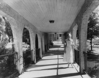 Ellen Low standing in one of Madison Sanitarium's covered corridors