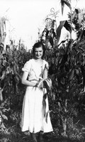Ellen A. Low standing in the corn field at Madison College