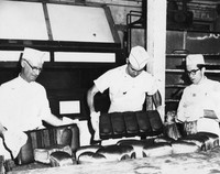 John Brownlee and two unknown men baking bread