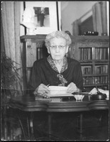 Bessie DeGraw sitting at a desk