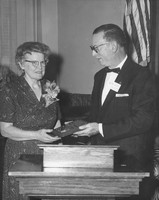 Bernard V. Bowen presents a plaque Mabel Towery