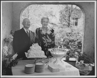Edward and Bessie Sutherland posing with their wedding cake