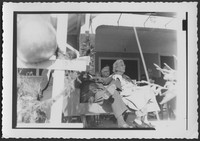 M. Bessie DeGraw sitting next to Edward Sutherland on a porch at Madison College during a ceremony